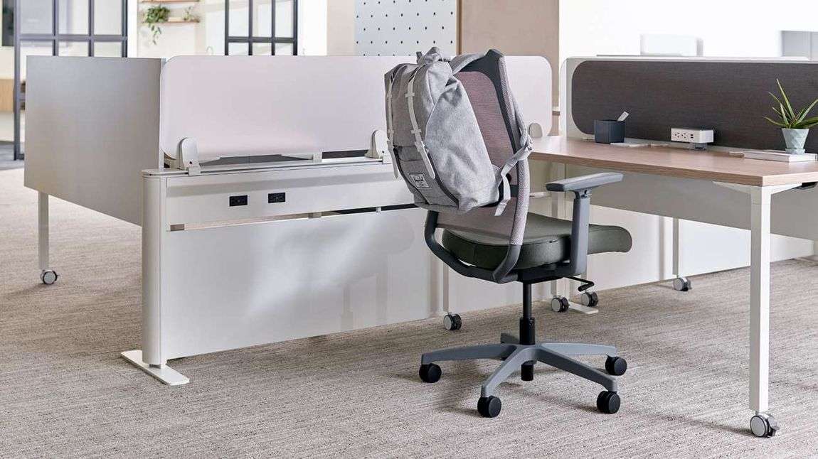 Chair at desktop for one in hybrid office.