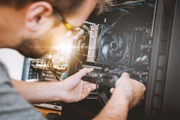 Man fixing a computer in an IT profession