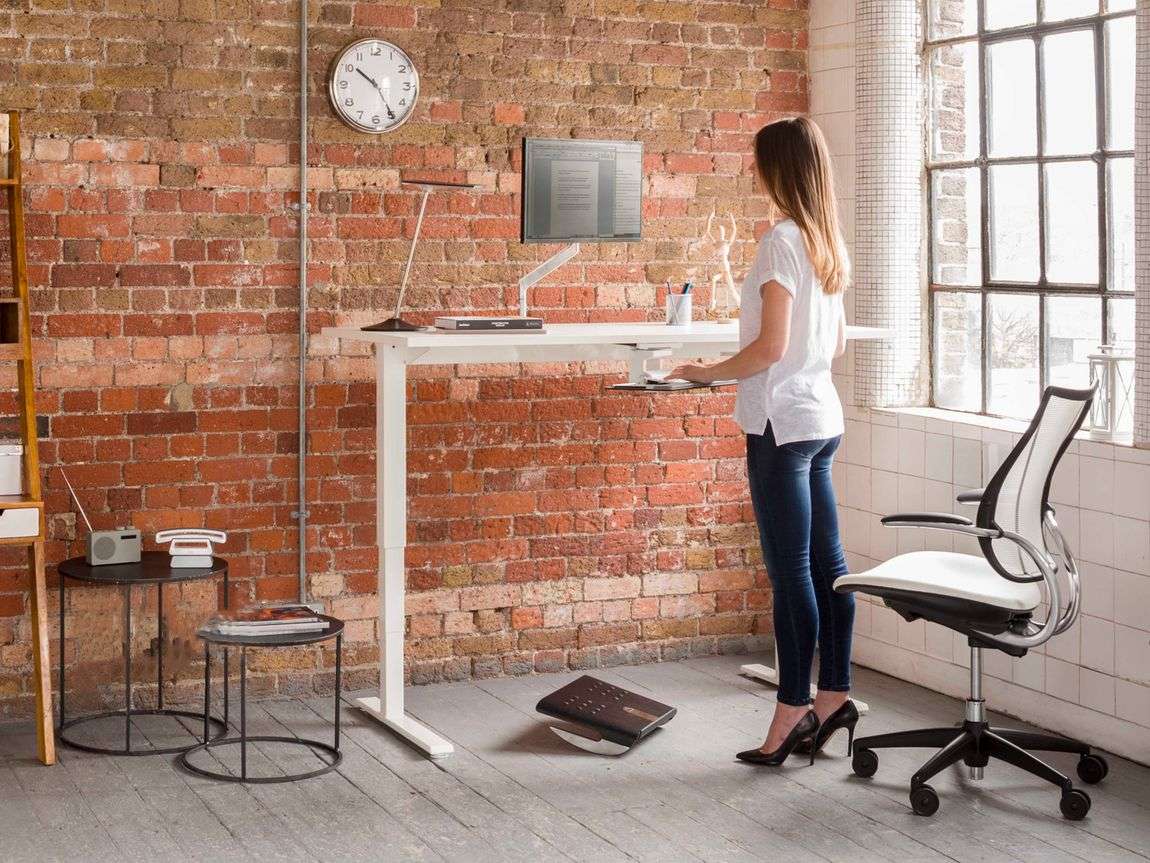 man at executive minimalist adjustable height desk