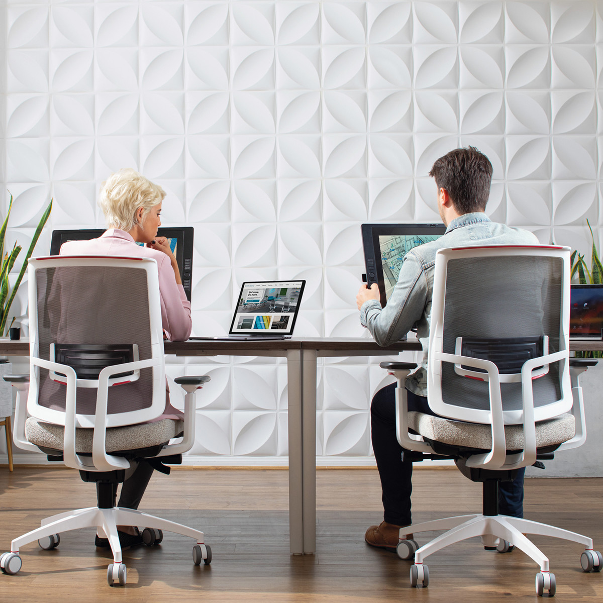 touchscreen computer monitor in a modern commercial office setting with ergonomic task chairs