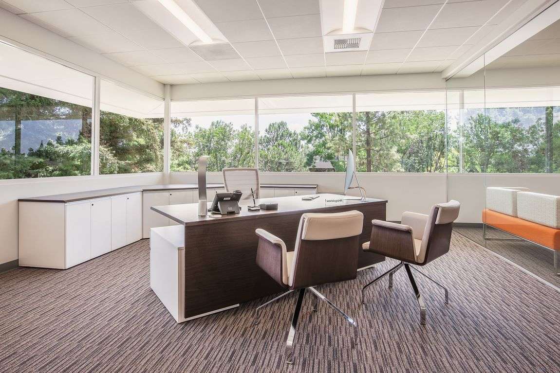executive office with a modern executive desk and modern versatile chairs